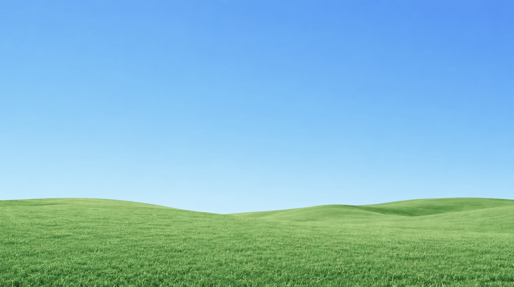 Rolling green hills under a blue sky